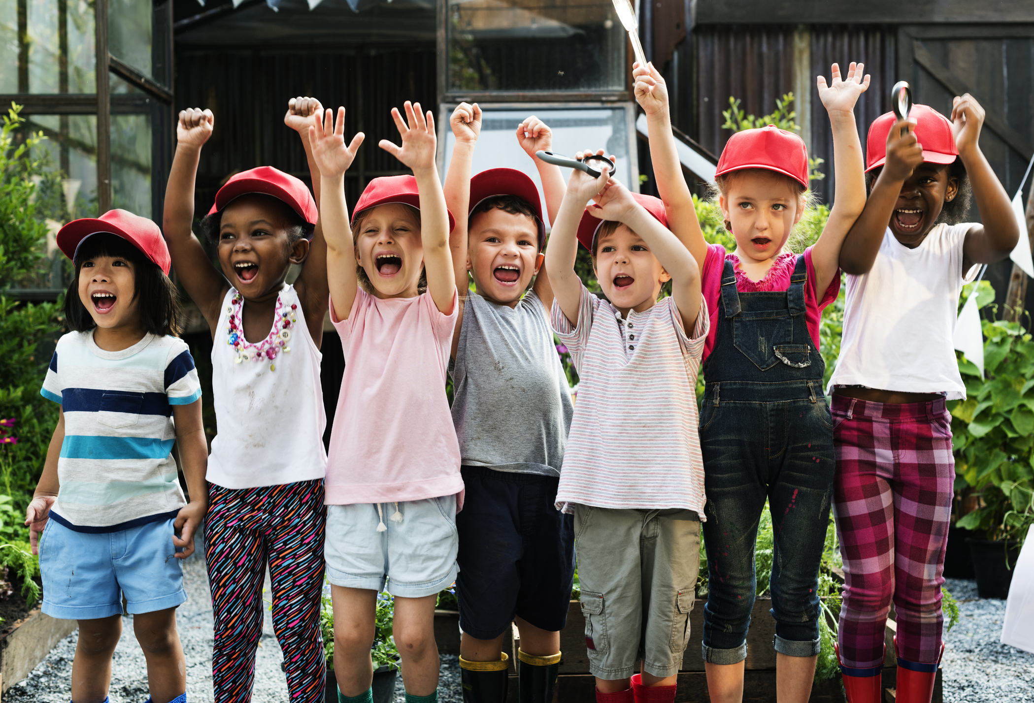 Group of children arms raised outdoors
