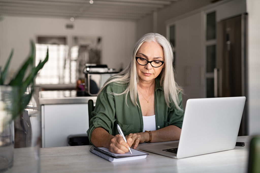 Mature woman working from home at laptop