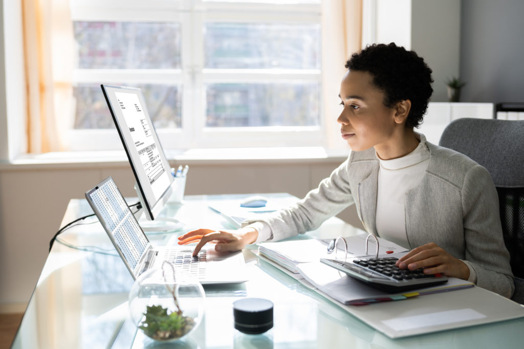 woman at computer doing work in home office