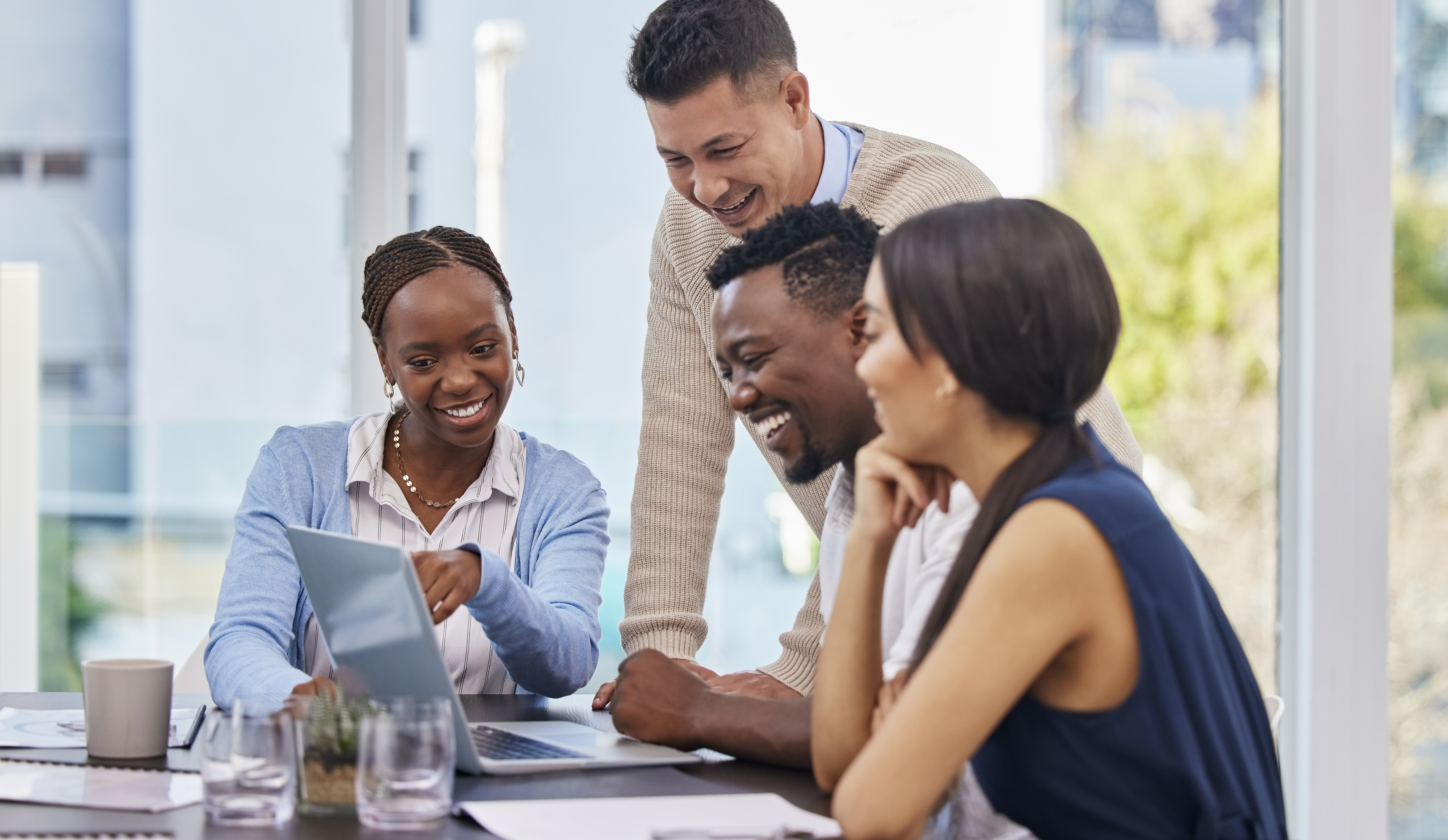 A group of business people looking at a laptop during a meeting.
