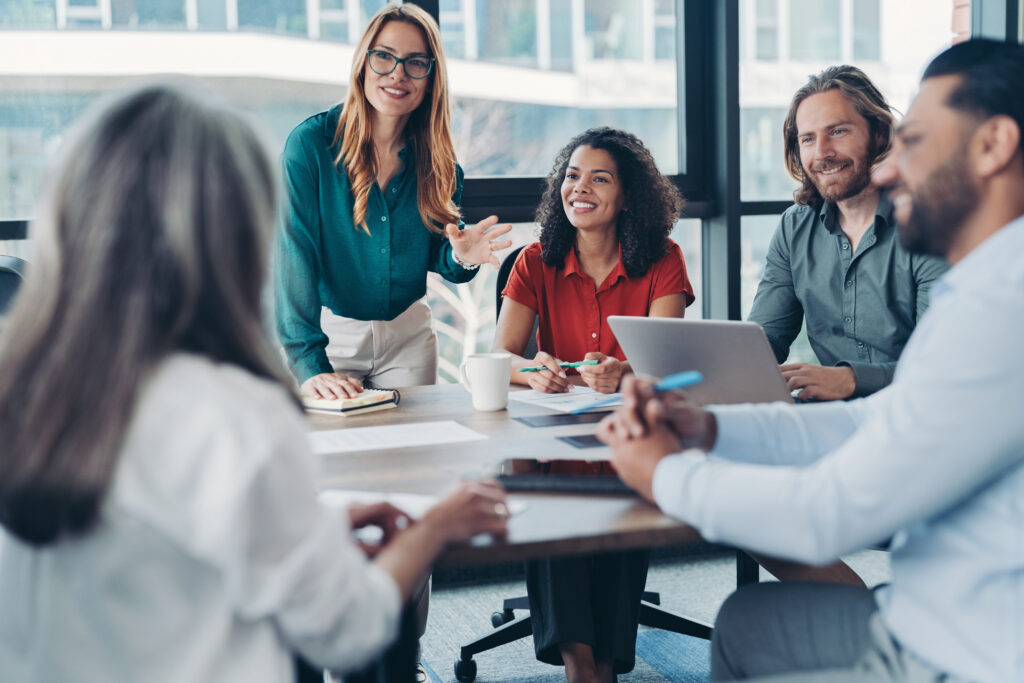 A small group of business professionals engaged in a meeting.