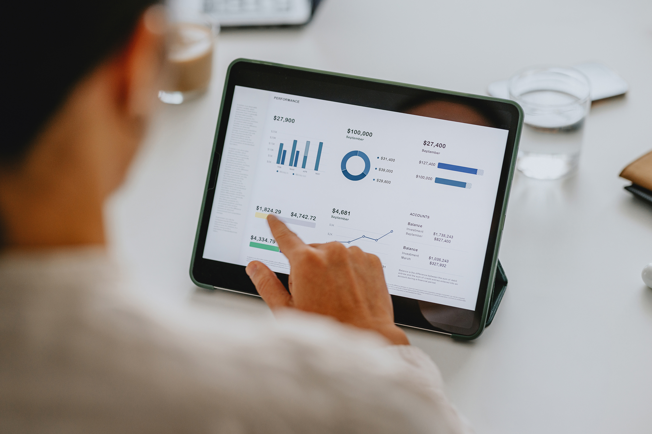 A business professional reviewing financial data on tablet in office